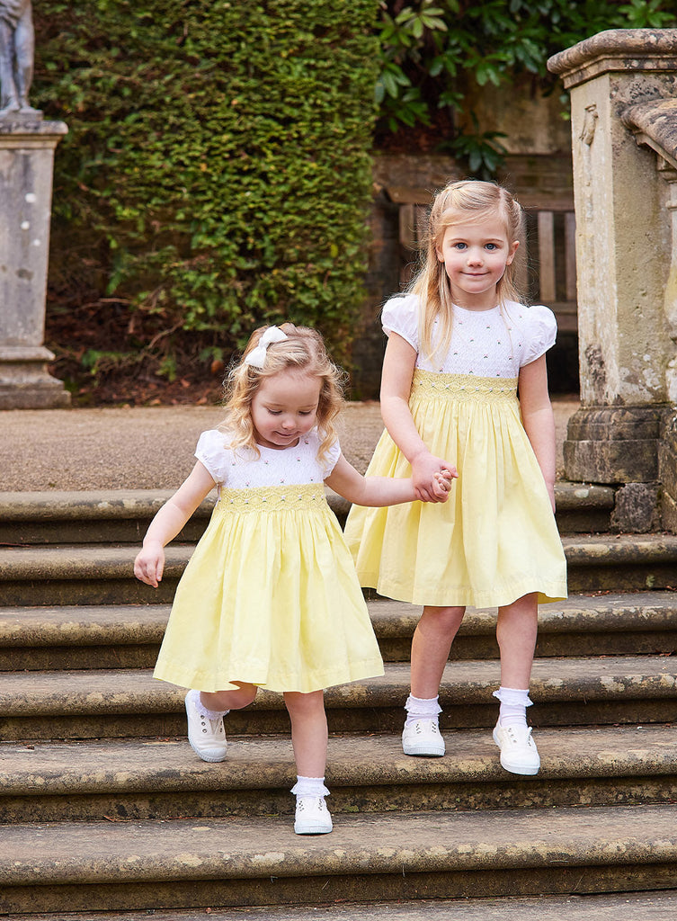 Girls Rose Hand Smocked Dress in Lemon Yellow | Trotters